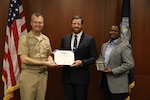 Naval Surface Warfare Center, Philadelphia Division (NSWCPD) Commanding Officer Capt. Joseph Darcy (left) and Technical Director Nigel C. Thijs (right), SES, present NSWCPD Alteration Installation Team Manager Jager Ziegenfuss with the Department of the Navy Civilian Service Achievement Medal during NSWCPD’s Fiscal Year (FY) 2023 Third Quarter Awards Ceremony on Aug. 29, 2023. (U.S. Navy photo by Phillip Scaringi/Released)