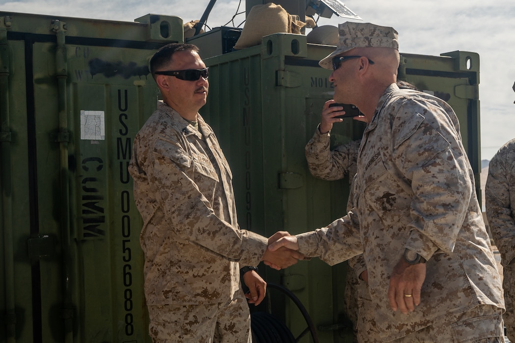 U.S. Marine Corps Lt. Gen. David Bellon, commanding general of U.S. Marine Corps Forces South and U.S. Marine Corps Forces Reserve, presents a coin to Sgt. Joseph Clever, an air traffic controller with Marine Air Control Squadron 24, 4th Marine Aircraft Wing, Marine Forces Reserve at Marine Corps Air-Ground Combat Center, Twentynine Palms, California, as part of Integrated Training Exercise 4-23, June 22, 2023. As the Marine Corps Reserve’s premier annual training event, ITX provides opportunities to mobilize geographically dispersed forces for a deployment; increase combat readiness and lethality; and exercise MAGTF command and control of battalions and squadrons across the full spectrum of warfare. Clever is a native Las Cruces, New Mexico.