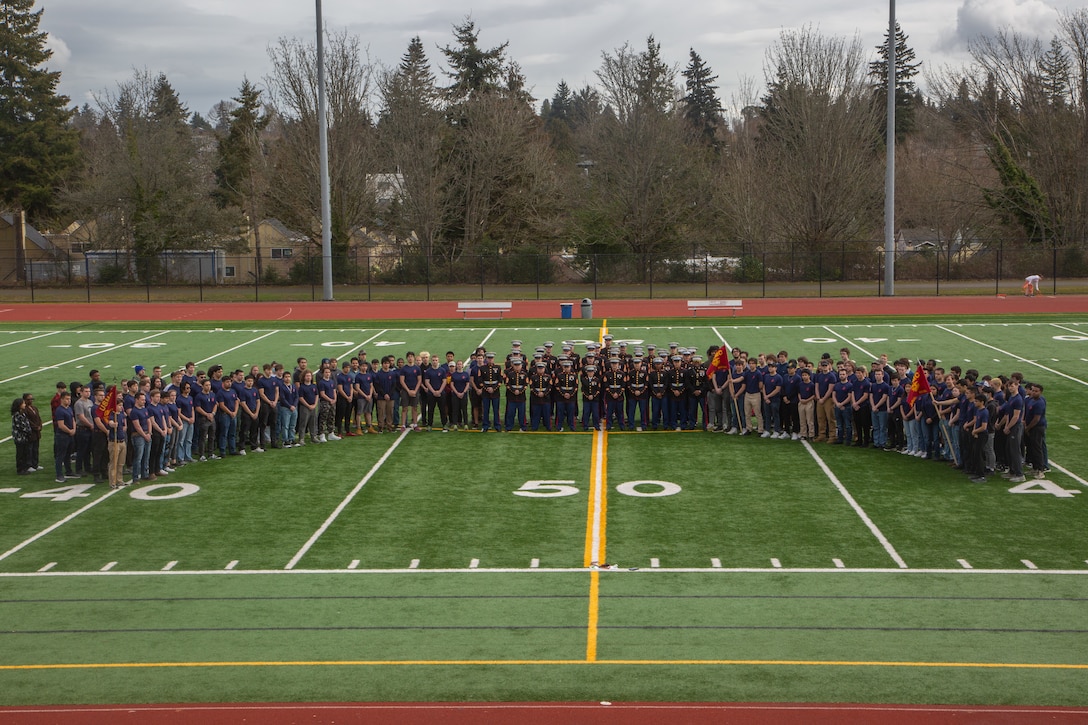 U.S. Marine Corps recruiters and future Marines with Recruiting Station Seattle pose for a group photo at Chief Sealth International High School in Seattle, Wash., March 11, 2023.  This community came together from all over Washington to watch Marine Barracks Washington perform during a family day event. (U.S. Marine Corps photo by Sgt, Stephen Campbell)