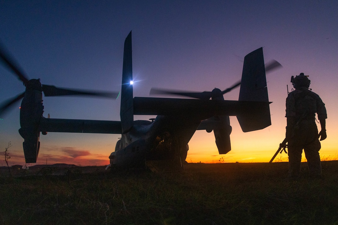 A U.S. Marine with 1st Reconnaissance Battalion, 1st Marine Division, observes Marines and members of 2nd Battalion, Royal Australian Regiment, load onto an MV-22B Osprey at Marine Corps Base Camp Pendleton, California, Sept. 26, 2023. Members of 2RAR worked alongside 1st Recon Bn. to execute a reconnaissance and surveillance insert from Camp Pendleton to Marine Corps Air Ground Combat Center Twentynine Palms, California, as part of a bilateral training exercise developed to strengthen the relationship, mission readiness and interoperability between 2RAR and 1st Recon Bn. (U.S. Marine Corps photo by Sgt. Taylor)