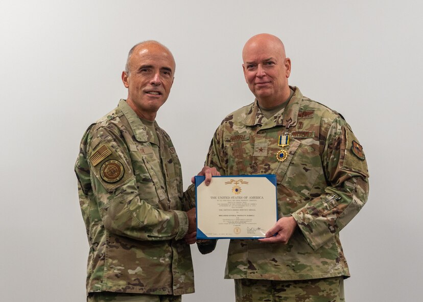 Lt. Gen. Robert Miller, U.S. Air Force Surgeon General, presents Brig. Gen. (Dr.) Thomas Harrell, 59th Medical Wing commander, with the Distinguished Service Medal at Wilford Hall Ambulatory Surgical Center, Joint Base San Antonio-Lackland, Texas, Oct. 11, 2023. He was recognized for his outstanding leadership and accomplishments achieved when he served as the Air Force Medical Readiness Agency commander. Harrell also currently serves as the Defense Health Network Central director, the San Antonio Market director, and the Air Force Medical Agency Alpha lead. (U.S. Air Force photo by Senior Airman Melody Bordeaux)