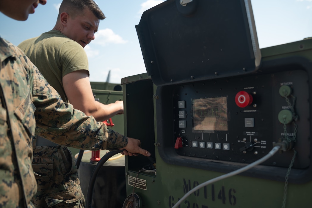U.S. Marines with Marine Wing Communications Squadron 48 (MWCS-48), refuel generators during Northern Lightning 23 at Volk Field Air National Guard Base, Wisconsin, Aug. 7, 2023. Northern Lightning is one of the seven Air National Guard joint accredited readiness exercises that increases military readiness by providing participating units a tactical, joint training environment to execute realistic combat training. (U.S. Marine Corps photo by Cpl. Ujian Gosun)