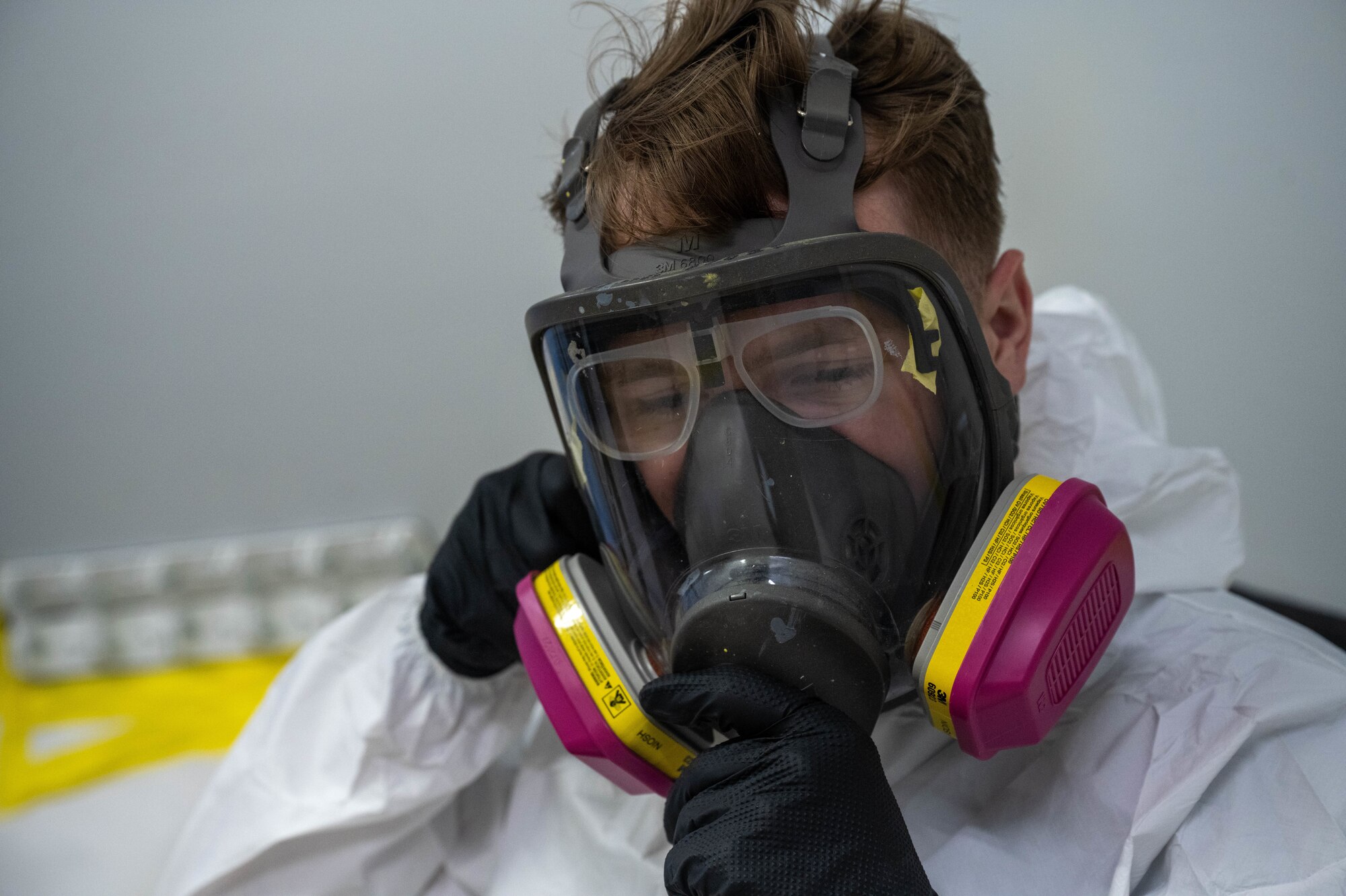 Airman 1st Class Tyler Edwards, 15th Maintenance Squadron aircraft structural maintenance journeyman, dons personal protective equipment in a new mobile paint booth at Joint Base Pearl Harbor-Hickam, Hawaii, Oct. 11, 2023. The mobile paint booth is a modular, customizable and deployable shelter that allows Airmen the capabilities to maintain and improve equipment in any environment. (U.S. Air Force photo by Senior Airman Makensie Cooper)