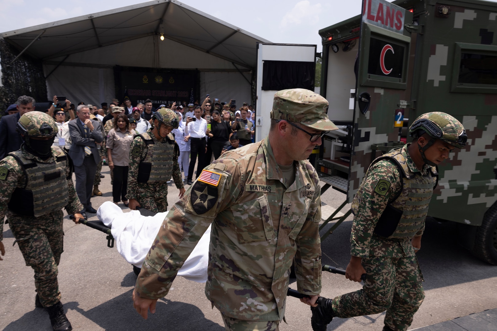 U.S. Army and Malaysian Armed Forces medics litter carry a mock-patient from an ambulance to a field hospital  recently handed over from U.S. Indo-Pacific Command to the MAF during Indo-Pacific Military Health Exchange 2023 in Kuala Lumpur, Malaysia, September 28, 2023. IPMHE is a biannual multilateral health engagement that allows medical professionals to exchange and share information amongst Allies and partners to discuss shared issues and concerns, and enhance regional interoperability. (U.S. Navy photo by U.S. Army Sgt. 1st Class Timothy Hughes/Released)