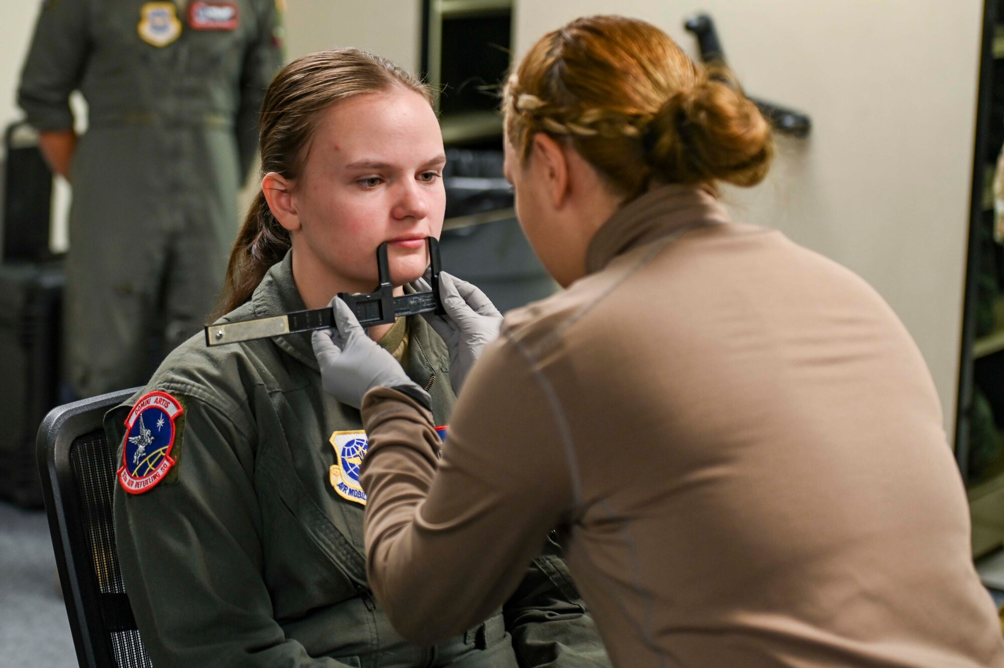 An Airman gets measured for an oxygen mask.