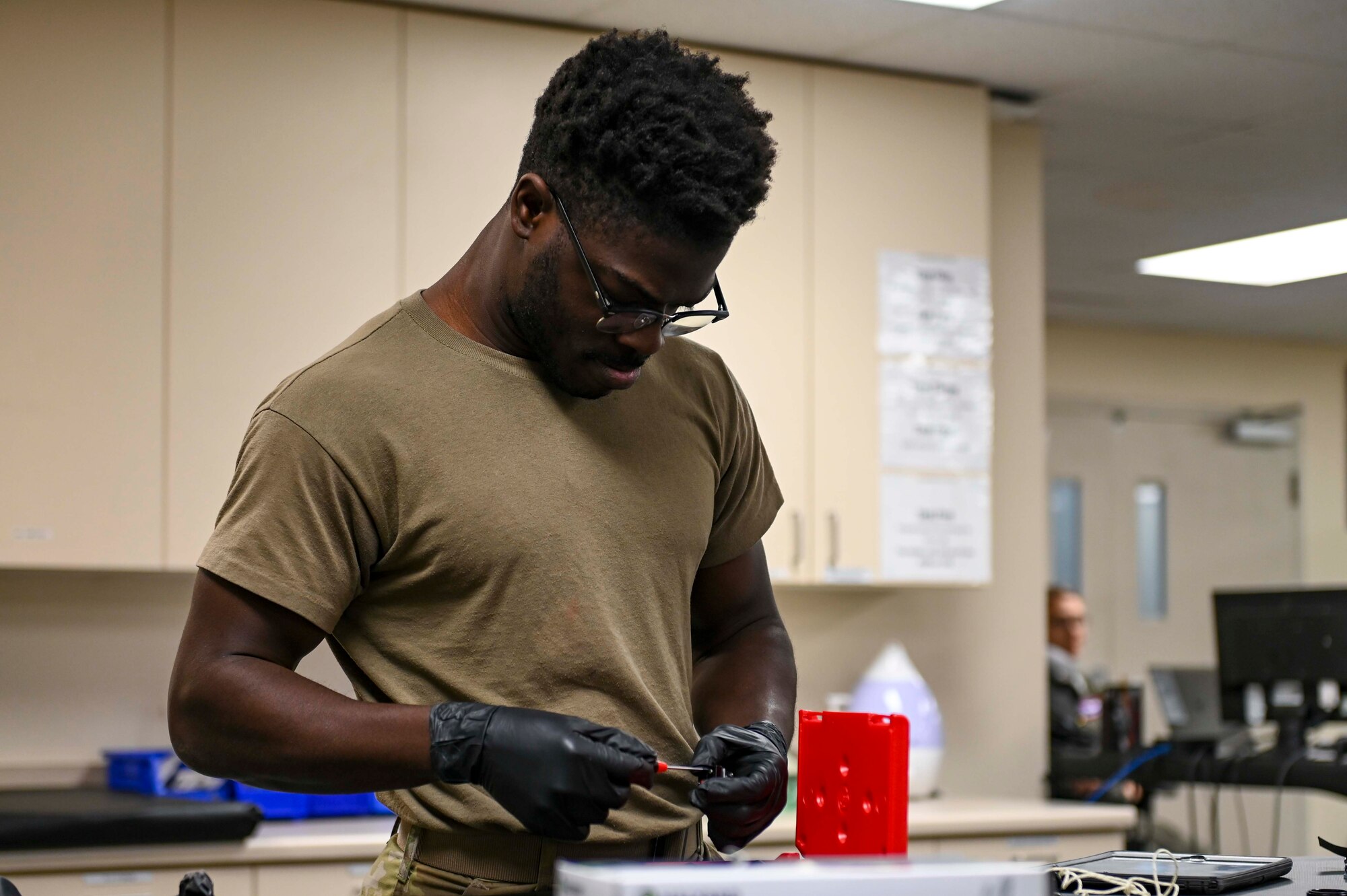An Airman assembles helmet equipment.