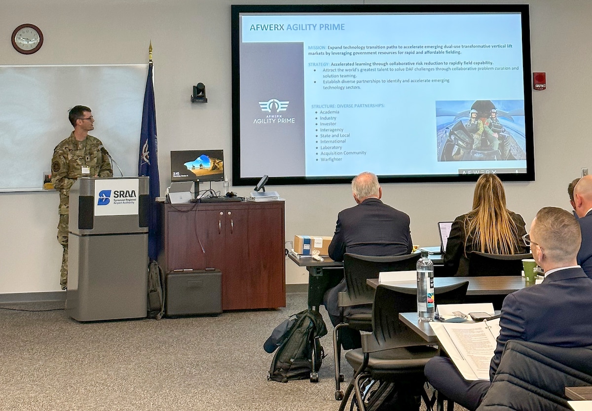 Lt. Col. John Tekell, AFWERX Agility Prime branch chief, gives a presentation highlighting how AFWERX brings cutting edge American ingenuity from small businesses and start-ups to address the most pressing challenges of the Department of the Air Force, Syracuse, New York, Oct. 11-13, 2023. (U.S. Air Force photo by Ciska Bloemhard)