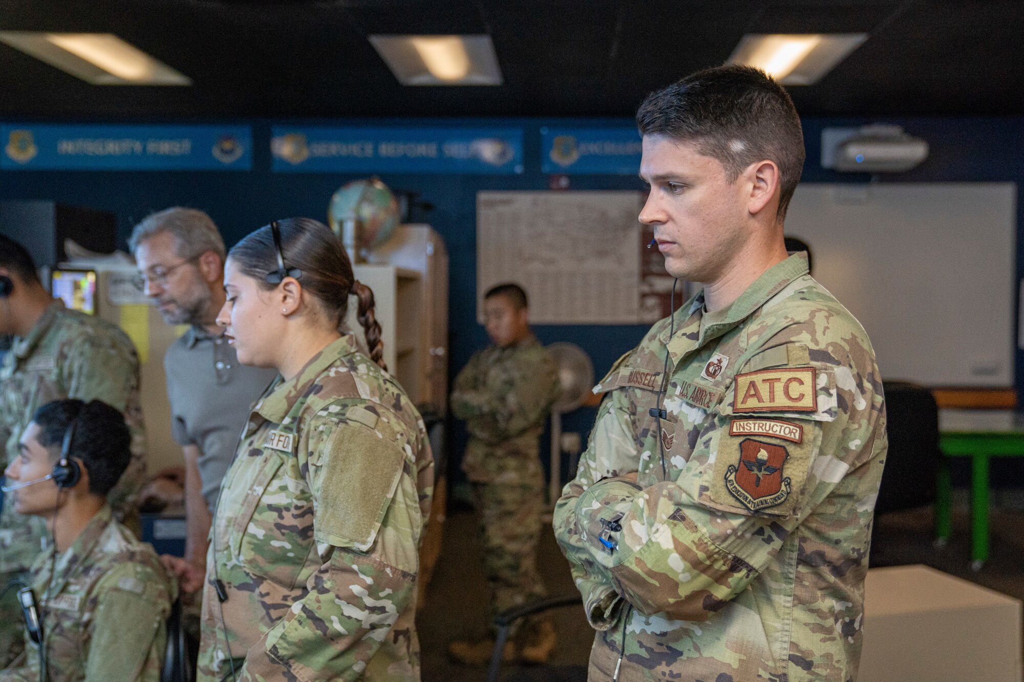 U.S. Air Force Staff Sgt. Michael Russell, 334th Training Squadron air traffic control instructor, observes a student taking their daily practical assessment at Keesler Air Force Base, Mississippi, Sept. 26, 2023.