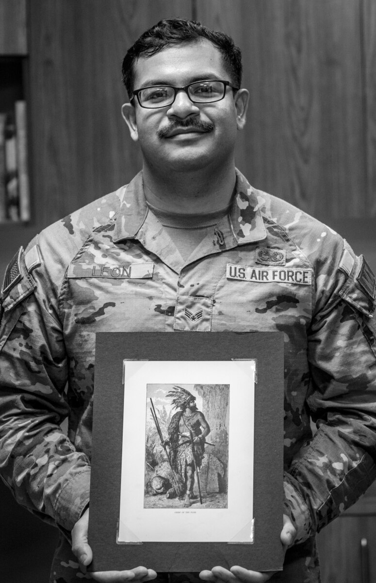 McChord Airman holds a piece of art that inspires him while he shares his story, and his Hispanic heritage.
