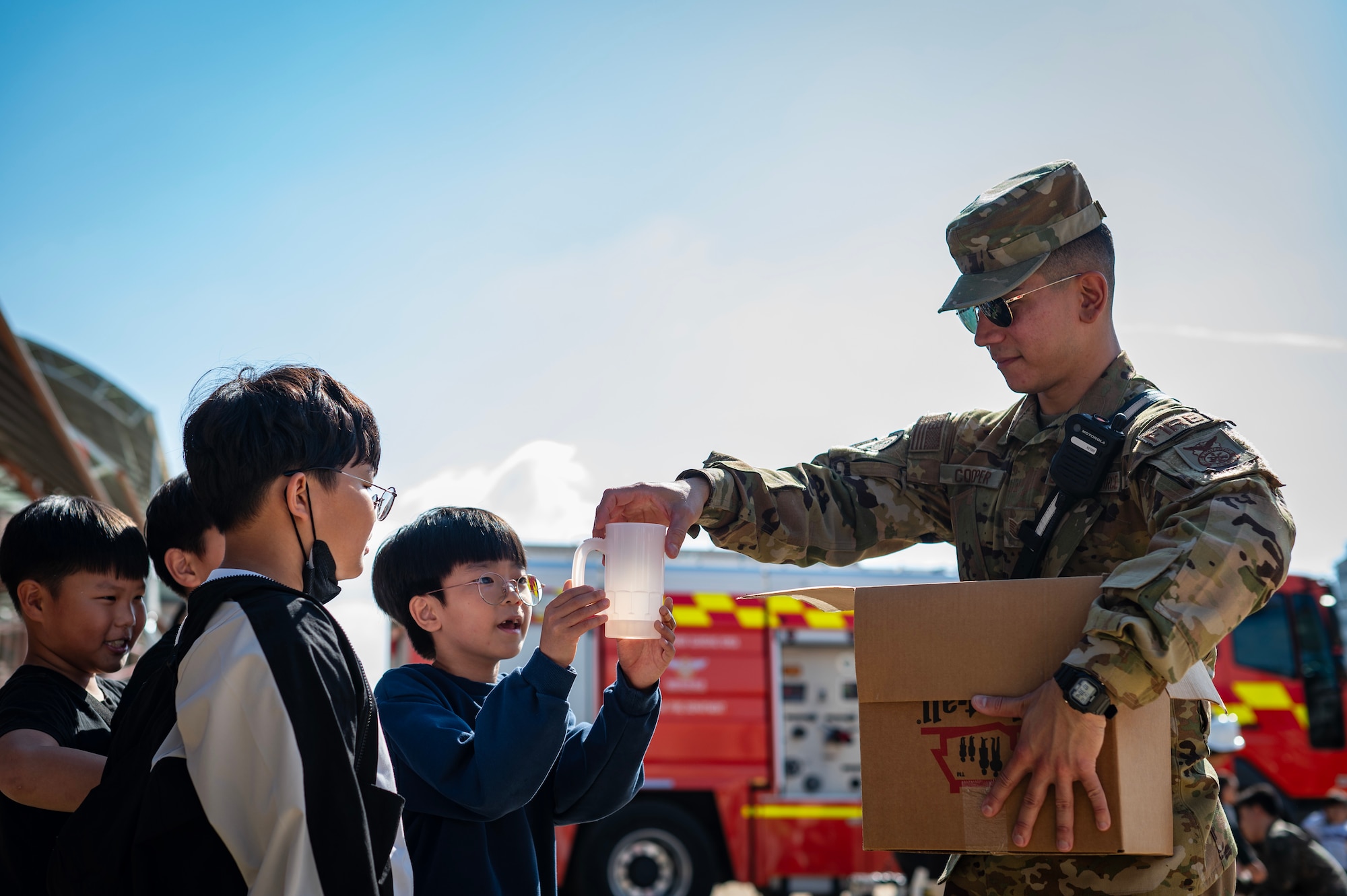 Tech. Sgt. Aaron Cooper distributes goods that promote and amplify fire safety messages.