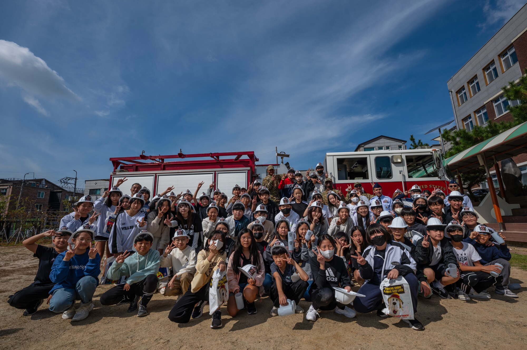 Members from the 8th Civil Engineer Squadron fire department gather for a photo with students from Gunsan Jigok Elementary School.