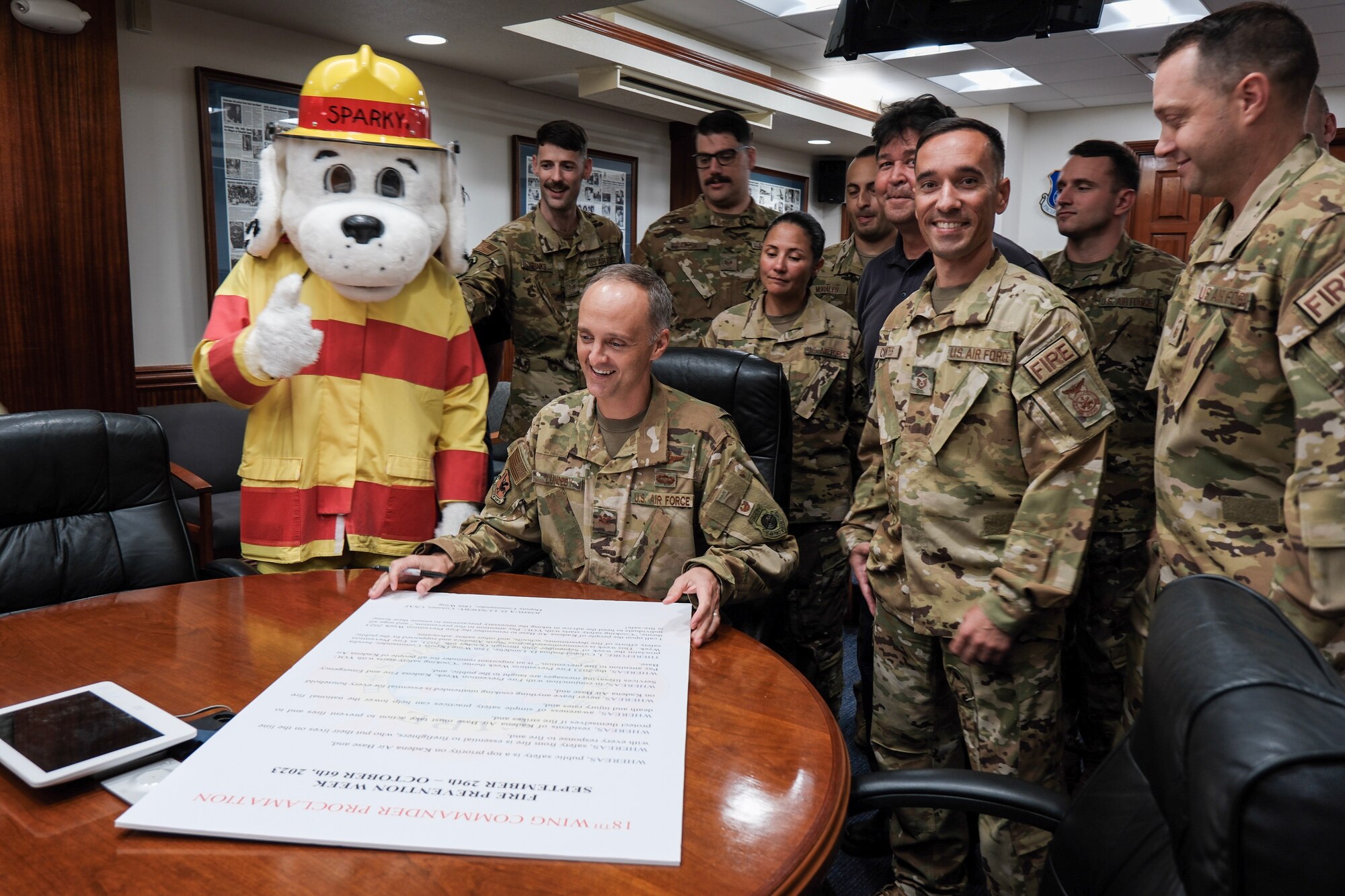 Col. Lundeby signs proclamation with 18th Wing Civil Engineer members