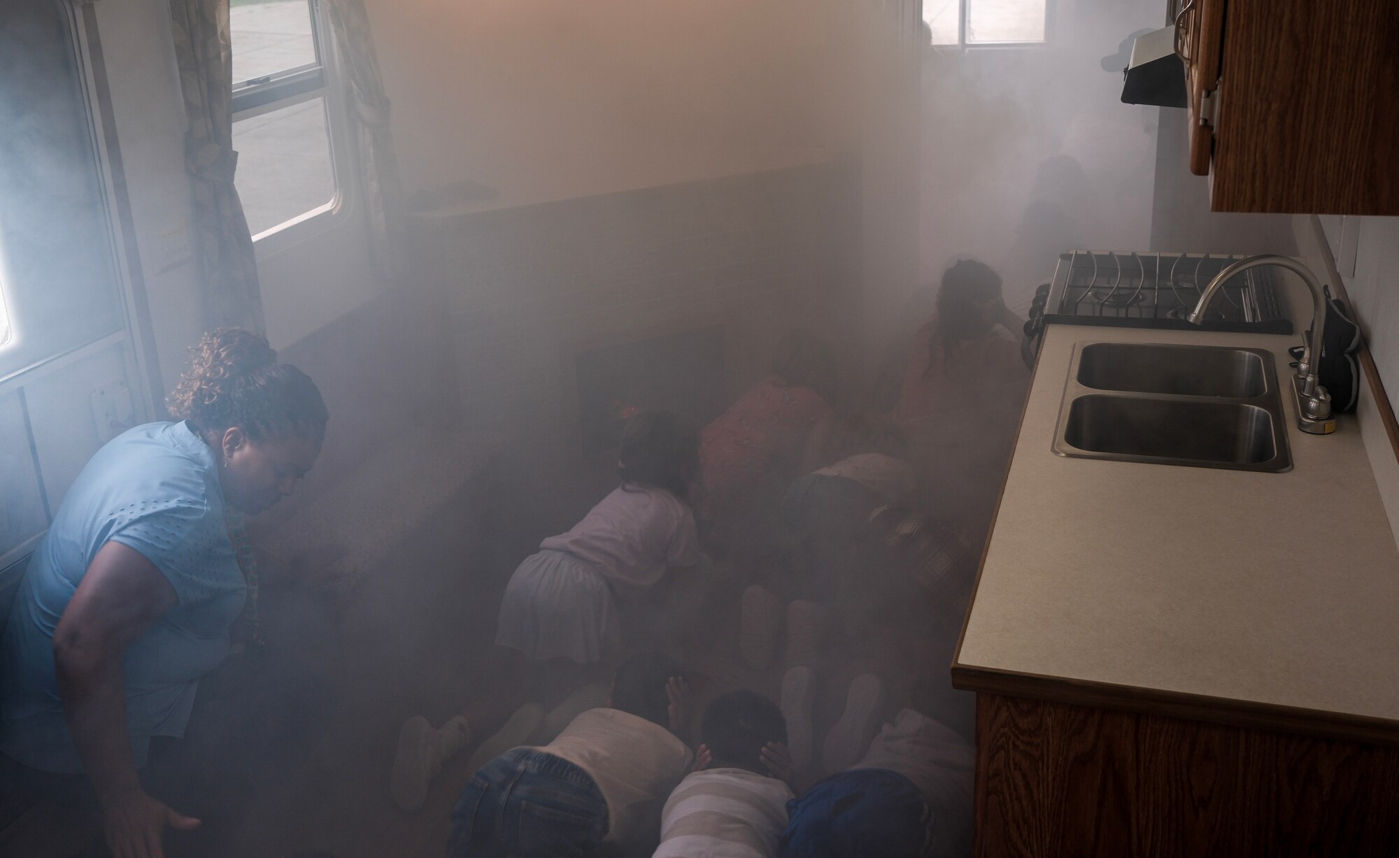 children participate in smoke demonstration inside of a car