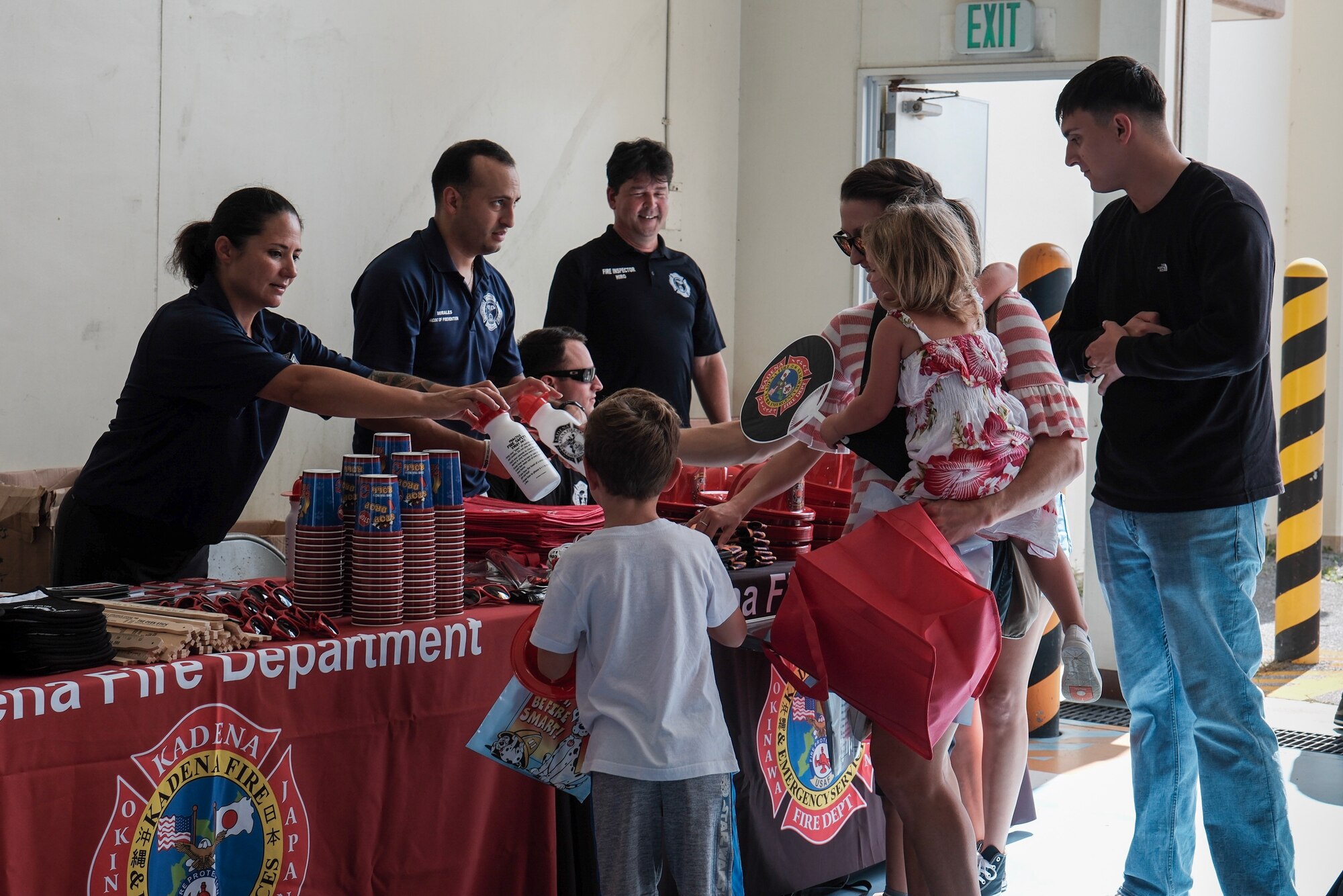 Fire Prevention worker hands gifts to children