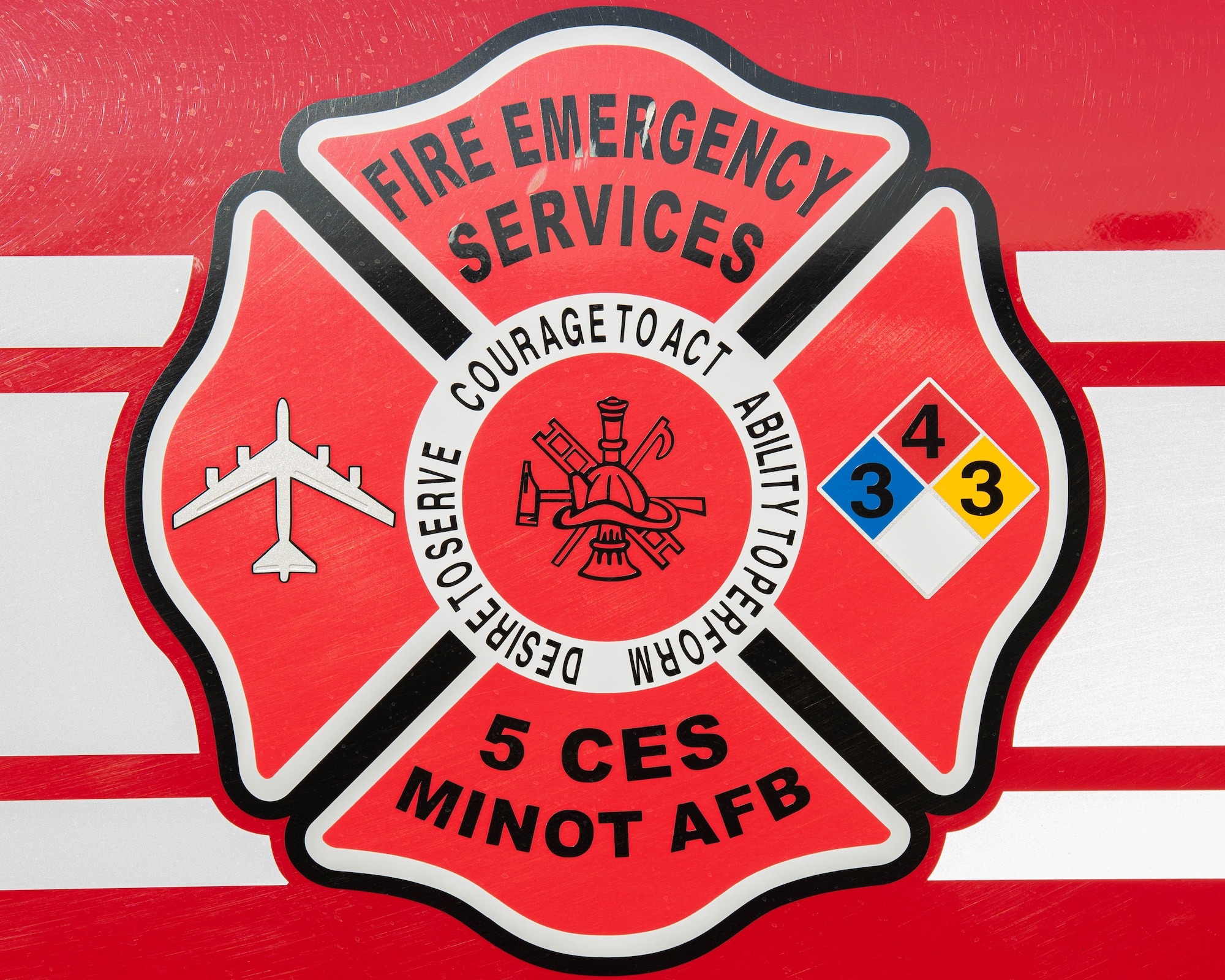 The Minot Air Force Base Fire and Emergency Services (FES) emblem is displayed on the side of a fire engine at Minot Air Force Base, North Dakota, Oct. 4, 2023. Minot AFB FES Airmen are responsible for responding in the event of fire and emergency situations on Minot AFB. (U.S. Air Force photo by Airman 1st Class Kyle Wilson)