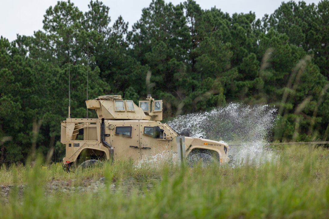 U.S. Marines with II Marine Expeditionary Force Support Battalion maneuver a Joint Light Tactical Vehicle around a driving course during Gladius Forge 23.2 at LZ Egret, Camp Lejeune, North Carolina, Sep. 26, 2023. Gladius Forge 23.2 is a II MSB field exercise in conjunction with 8th Communication Battalion, 2d Supply Battalion, and 2d Medical Battalion to execute mission essential tasks, while validating the battalion’s support capabilities and proficiency. (U.S. Marine Corps photo by Lance Cpl. Christian Alston)