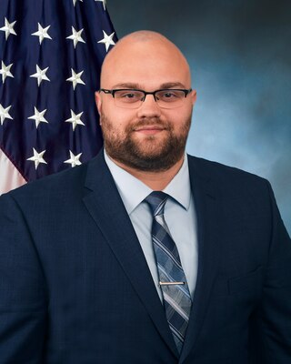 Official photo with flag and blue background