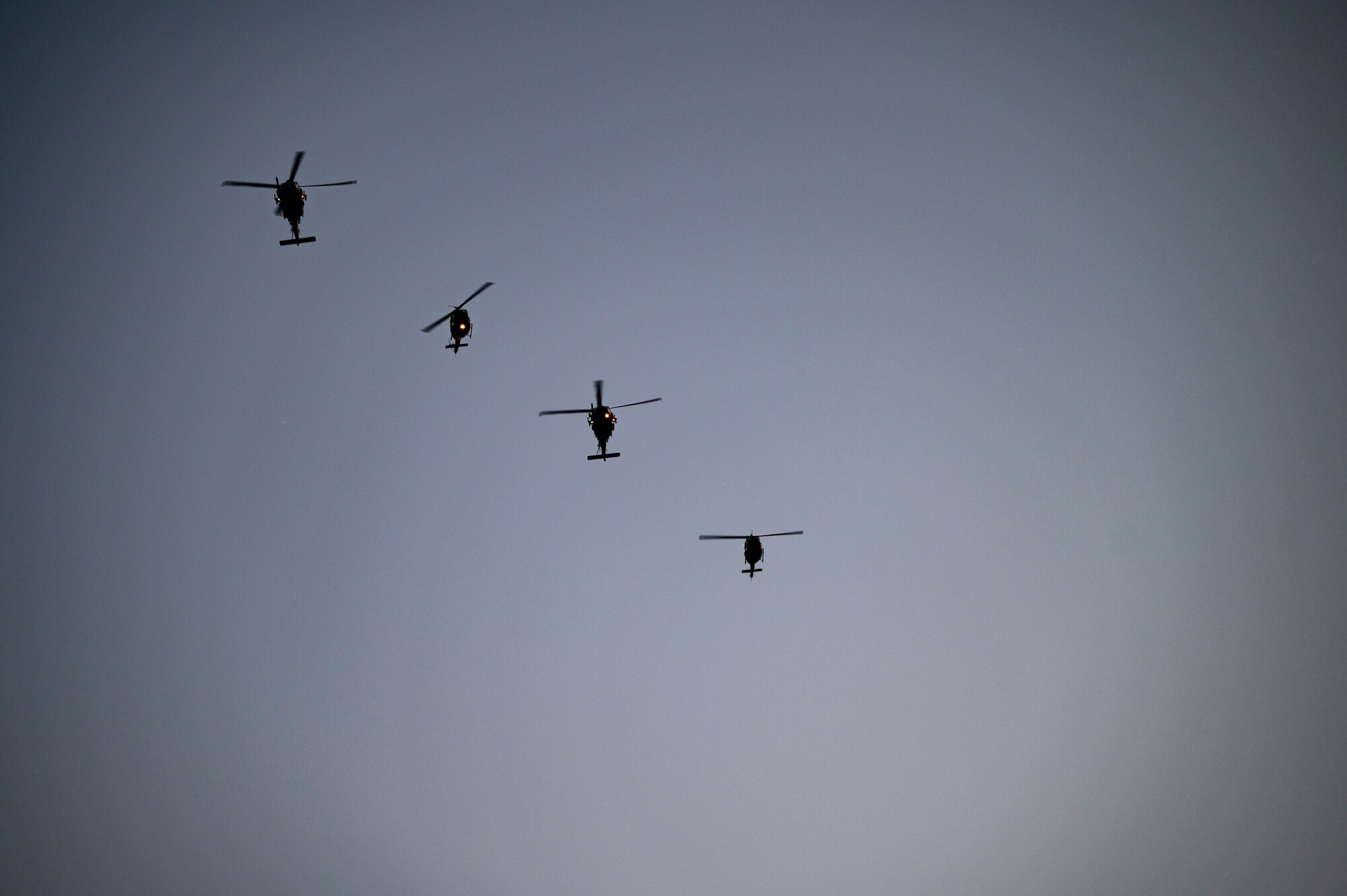 Helicopters fly in the sky