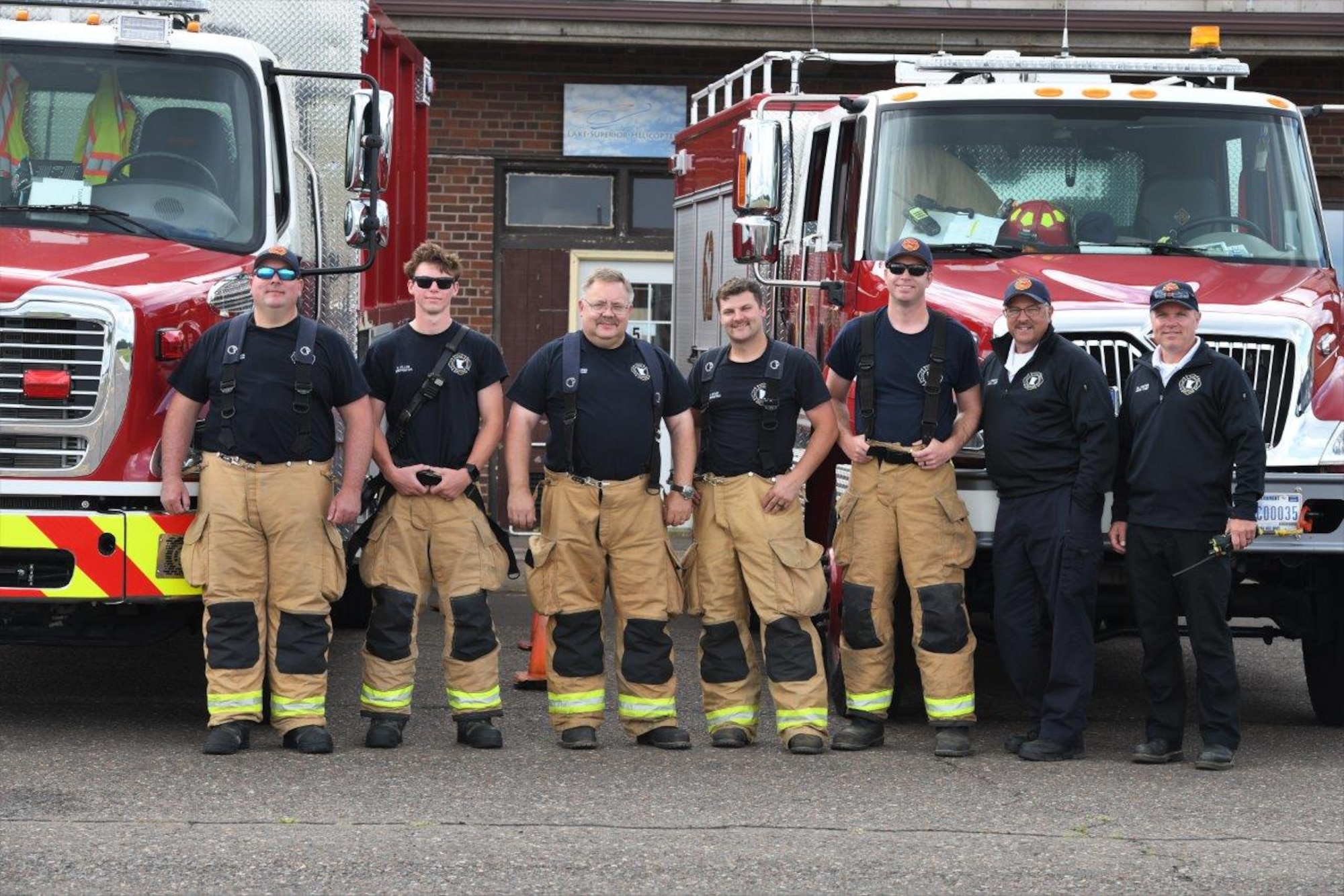 148th Fighter Wing Commander, Col. Nate Aysta, recognizes the crew of Fire Protection Specialists assigned to the 148th Fighter Wing, Minnesota Air National Guard, who responded to two Leap Frog Navy Parachute Team members who released and detached at a lower-than-normal altitude at the Duluth Airshow on July 15, 2023. (U.S. Air National Guard photo by Audra Flanagan)