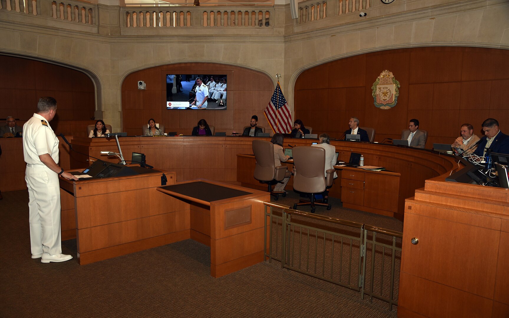 SAN ANTONIO – (Oct. 12, 2023) – Capt. Walter Brafford, commander, Naval Medical Forces Support Command (NMFSC) and director, U.S. Navy Dental Corps, addresses San Antonio Mayor Ron Nirenberg and City Council members during a City Council Session which included a cake-cutting ceremony to recognize the U.S. Navy’s 248th birthday at the Municipal Plaza. Joining Brafford at the session were Sailors from NMFSC, Naval Medical Research Unit (NAMRU) San Antonio, Navy Talent Acquisition Group (NTAG) San Antonio, and Navy veterans. (U.S. Navy photo by Burrell Parmer, NAMRU San Antonio Public Affairs/Released)