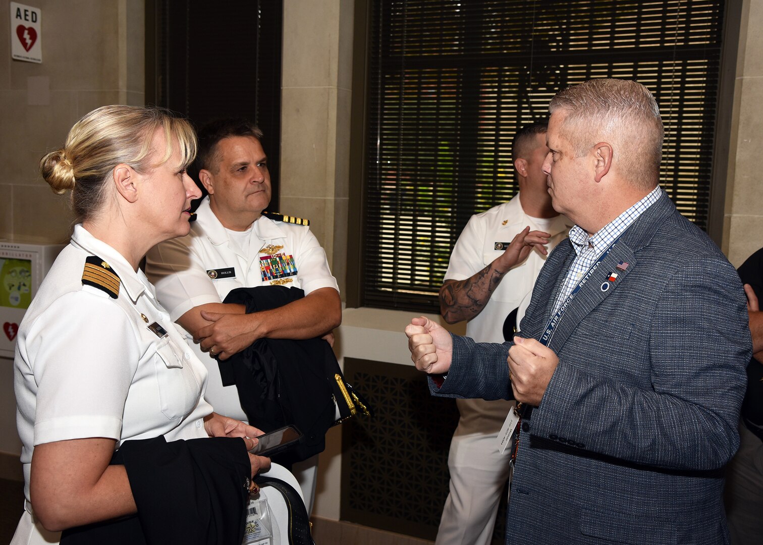 SAN ANTONIO – (Oct. 12, 2023) – Tim Woliver, assistant to the director, Military and Veteran Affairs Department of the City of San Antonio, speaks with Capt. Jennifer Buechel, commanding officer, Naval Medical Research Unit (NAMRU) San Antonio and Executive Officer Capt. Ewell Hollis at the Municipal Plaza prior to the start of a City Council Session which honored the U.S. Navy’s 248th birthday with a cake-cutting ceremony. (U.S. Navy photo by Burrell Parmer, NAMRU San Antonio Public Affairs/Released)