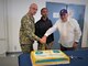 Master-at-Arms Senior Chief Frank Courtney (left), Yeoman Seaman Apprentice Alexander Quintero (center) and retired Master Chief Thomas Gomes (Right) represent the oldest sailor at the command, the youngest sailor, and the guest of honor for the command's Navy birthday ceremony conducted in the Port Operations Department earlier today.