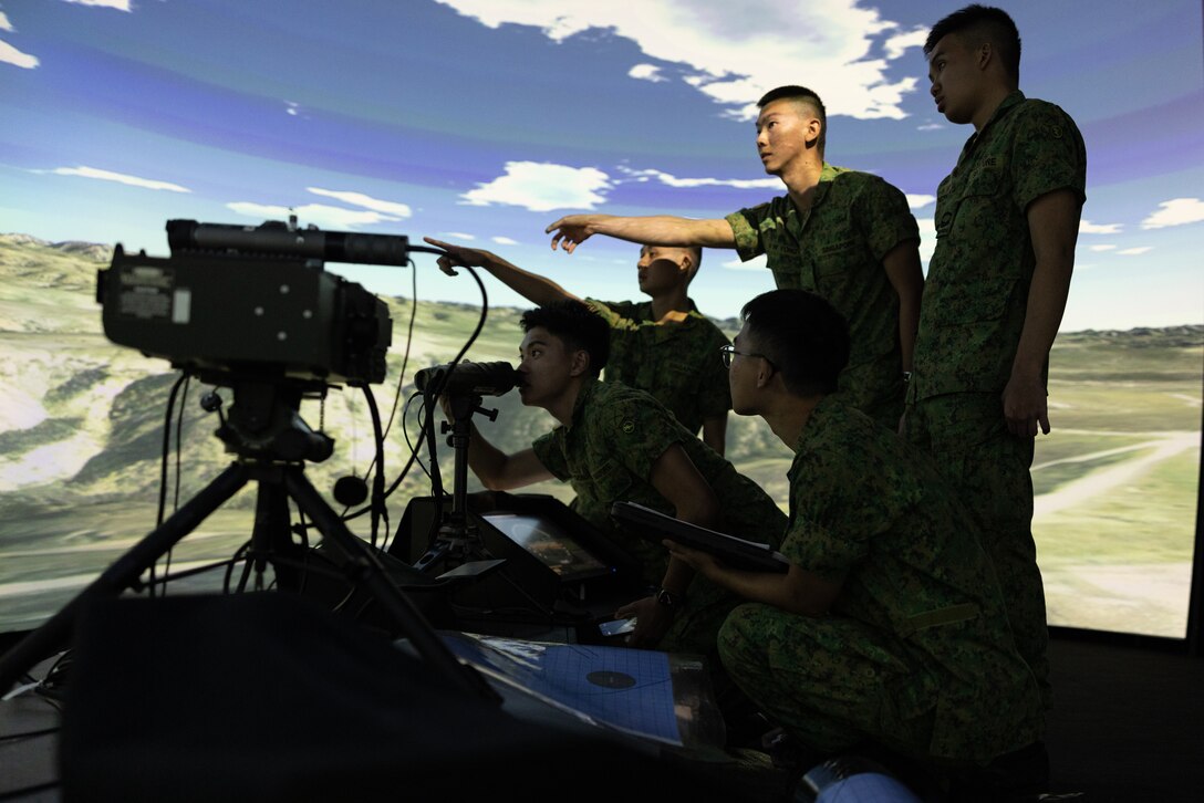 Singaporean Guardsmen with 7th Singapore Infantry Brigade conduct simulations in combined arms, fire support, and communications capabilities on the small arms virtual trainer as part of Valiant Mark 2023 at Camp Pendleton, CA, Oct. 10, 2023. Valiant Mark 23 is an annual, bilateral training exercise conducted between Singapore Armed Forces and I Marine Expeditionary Force, designed to enhance interoperability, improve combined arms and amphibious warfighting skills, and strengthen military-to-military relationships. (U.S. Marine Corps photo by Lance Cpl. Samantha Devine)
