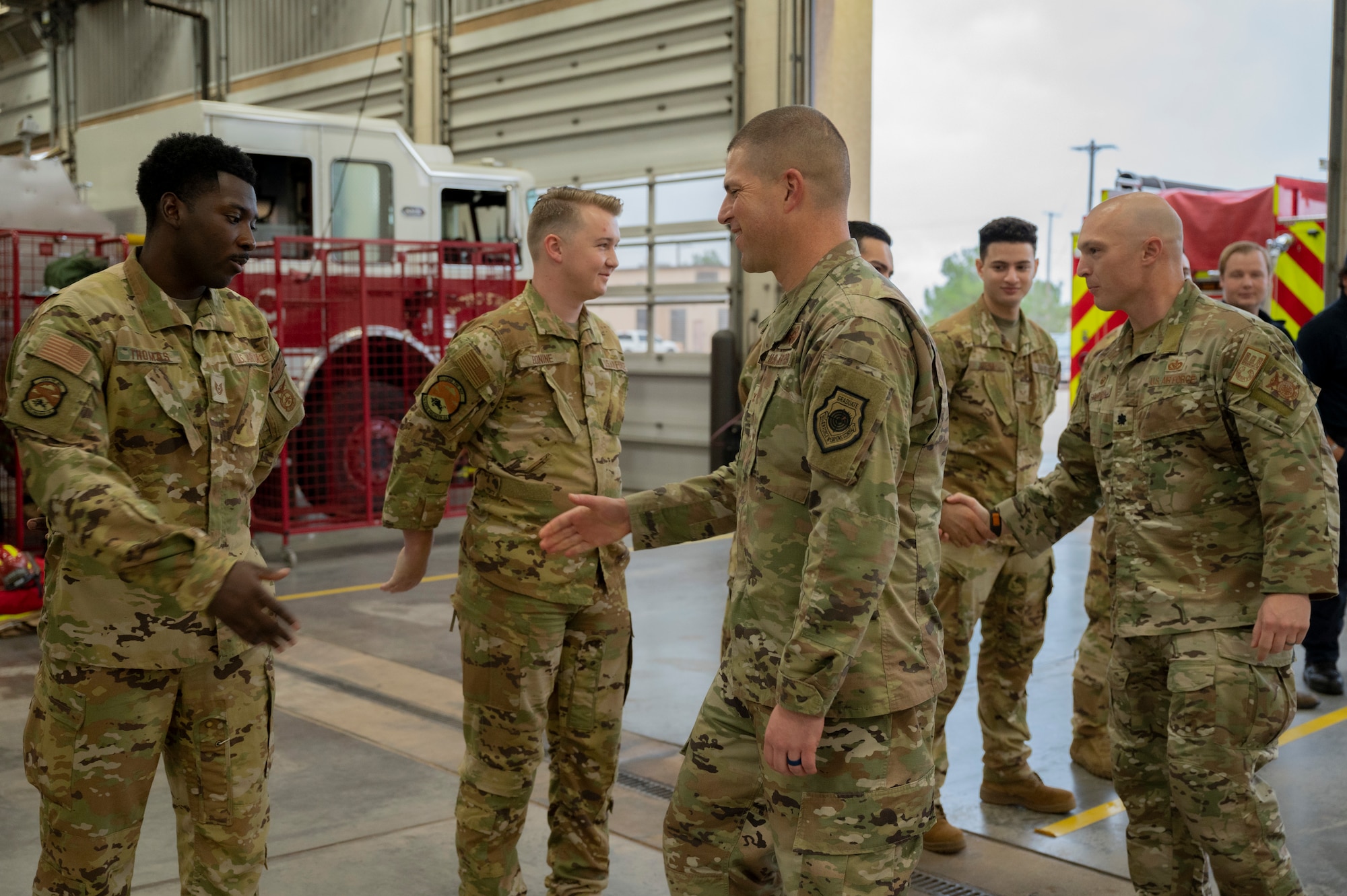 Col. Seth Spanier, 7th Bomb Wing commander, shakes hands with members of the 7th Civil Engineer Squadron fire department during Fire Prevention Week at Dyess Air Force Base, Texas, Oct. 5, 2023. This year's Fire Prevention Week campaign, "Cooking safety starts with you, pay attention to fire prevention,” informed the public of the risks of kitchen fires and to use caution when cooking. (U.S. Air Force photo by Airman 1st Class Alondra Cristobal Hernandez)