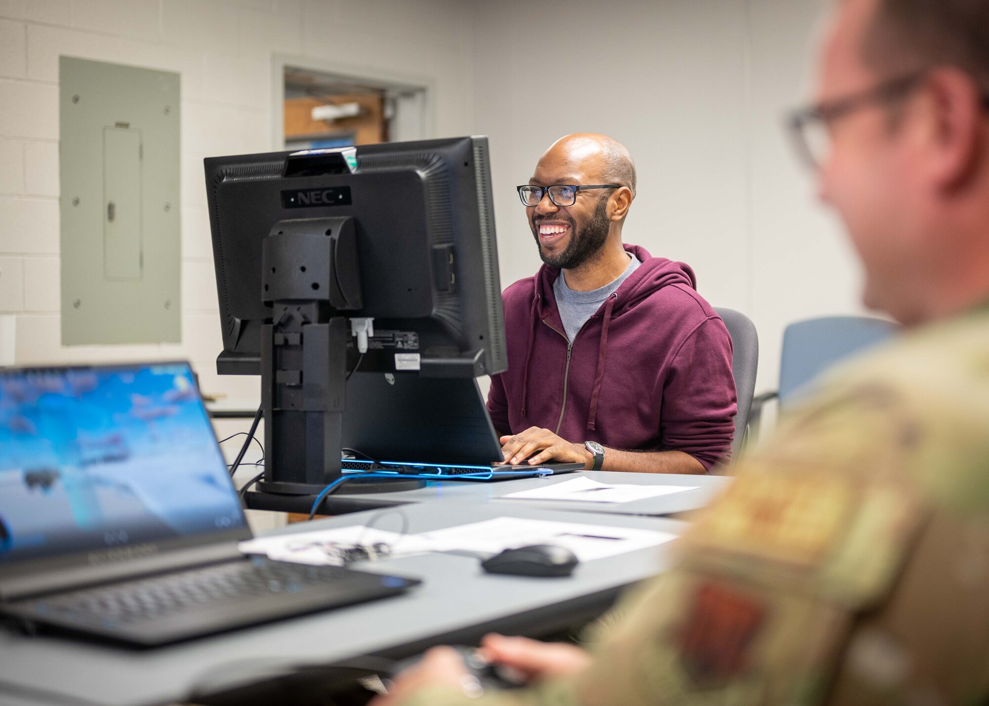 An Airman smiles while playing the game.