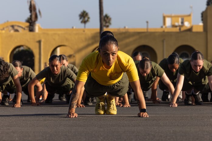 U.S. Marine Corps Staff Sgt. Jeanette Peraza, a senior drill instructor with Echo Company, 2nd Recruit Training Battalion, leads her platoon in warm-up exercises before a motivational run at Marine Corps Recruit Depot San Diego, Oct. 12, 2023. The motivational run is the last physical training exercise Marines conduct while at MCRD San Diego. Peraza is a native of Los Angeles. (U.S. Marine Corps photo by Cpl. Alex Devereux)