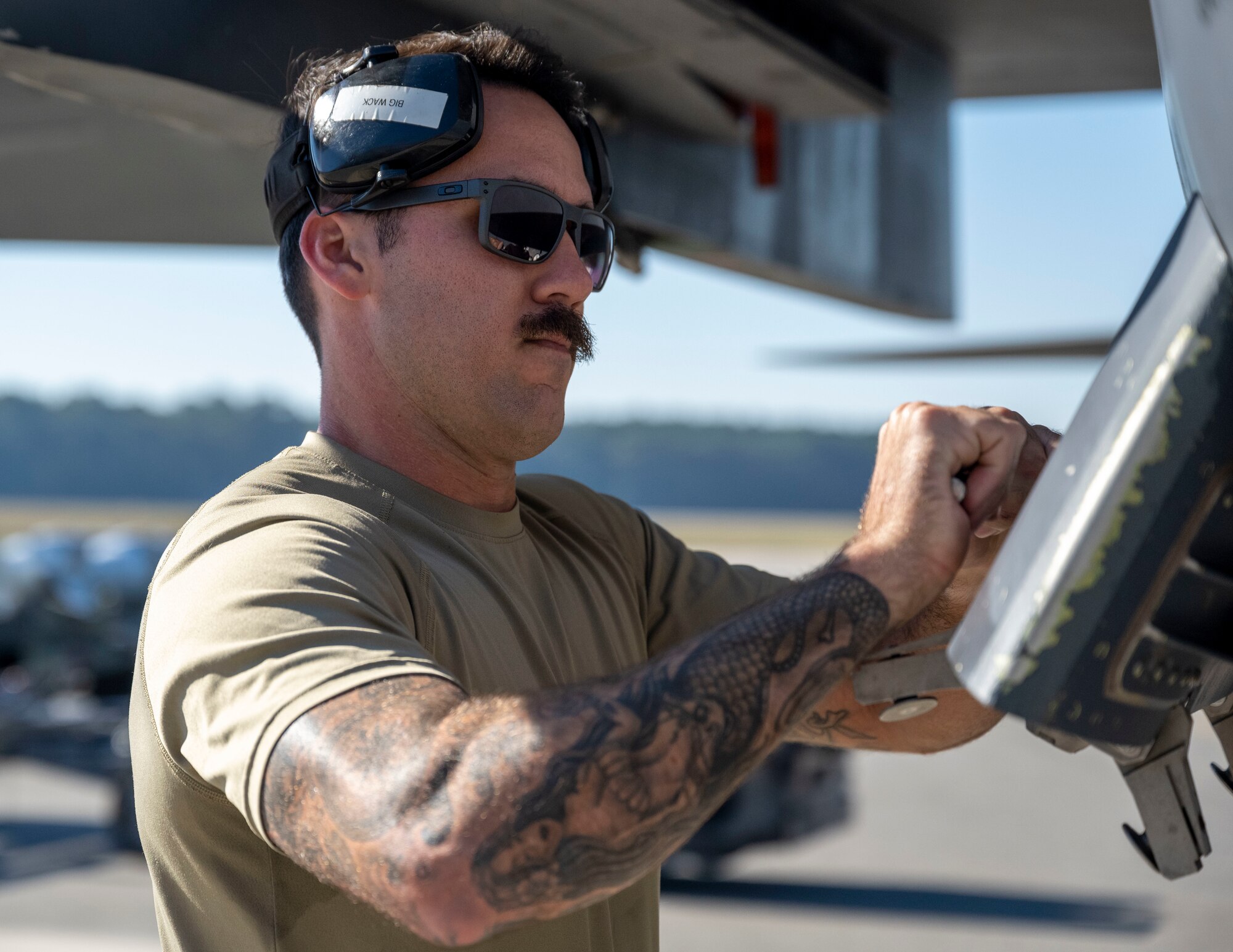 Senior Airman John Glasgow, 333rd Fighter Generation Squadron load crew member, tightens a bolt on an F-15E Strike Eagle during a quarterly load crew competition at Seymour Johnson Air Force Base, North Carolina, Oct. 13, 2023. Participants of the load crew competition are judged on their accuracy, efficiency and speed when loading munitions. (U.S. Air Force photo by Senior Airman David Lynn)
