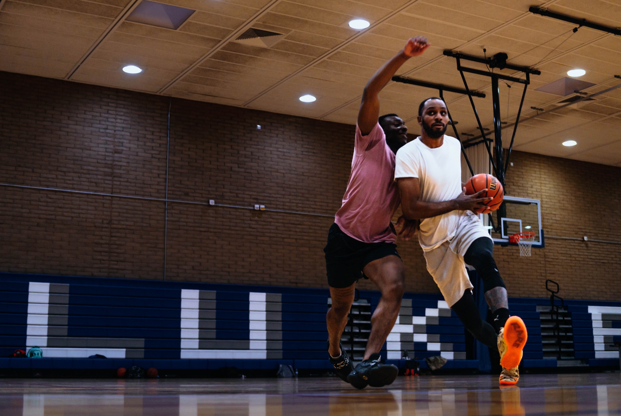 U.S. Air Force Senior Airman Ian Sutton (left), 944th Fighter Wing administrative helper, and Senior Airman Albert Madden (right), 56th Fighter Wing Communication Support Squadron technician, run a drill during a Thunderbolt basketball practice.