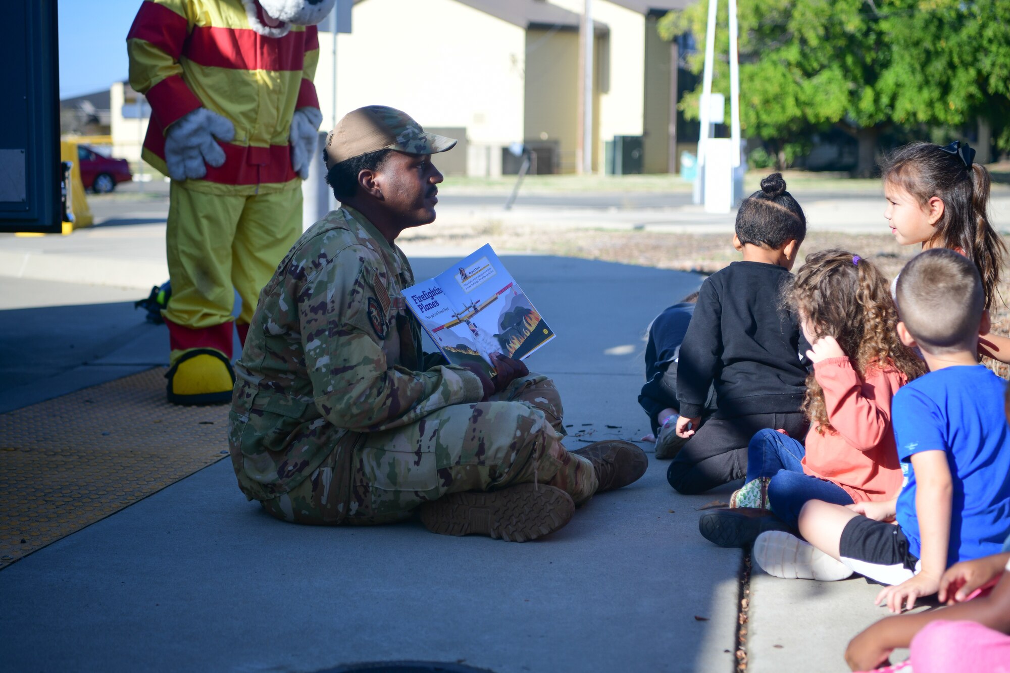 U.S. Air Force Senior Airman Keith Alexis, 9th Civil Engineer Squadron firefighter, reads a story to children at the Child Development Center on Beale Air Force Base, California, Oct. 11, 2023.