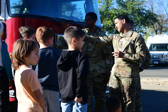 U.S. Air Force Senior Airman Micah Whitesanders, 9th Civil Engineer Squadron firefighter, teaches children about fire safety at the Youth Center on Beale Air Force Base, California, Oct. 11, 2023.