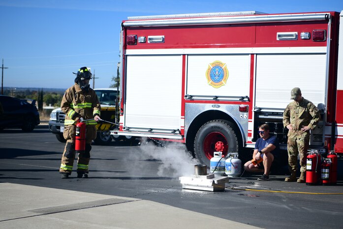 U.S. Air Force Airman 1st Class Kace Kauffman, 9th Civil Engineer Squadron firefighter, performs a fire demonstration at Lone Tree Elementary School on Beale Air Force Base, Oct. 11, 2023.