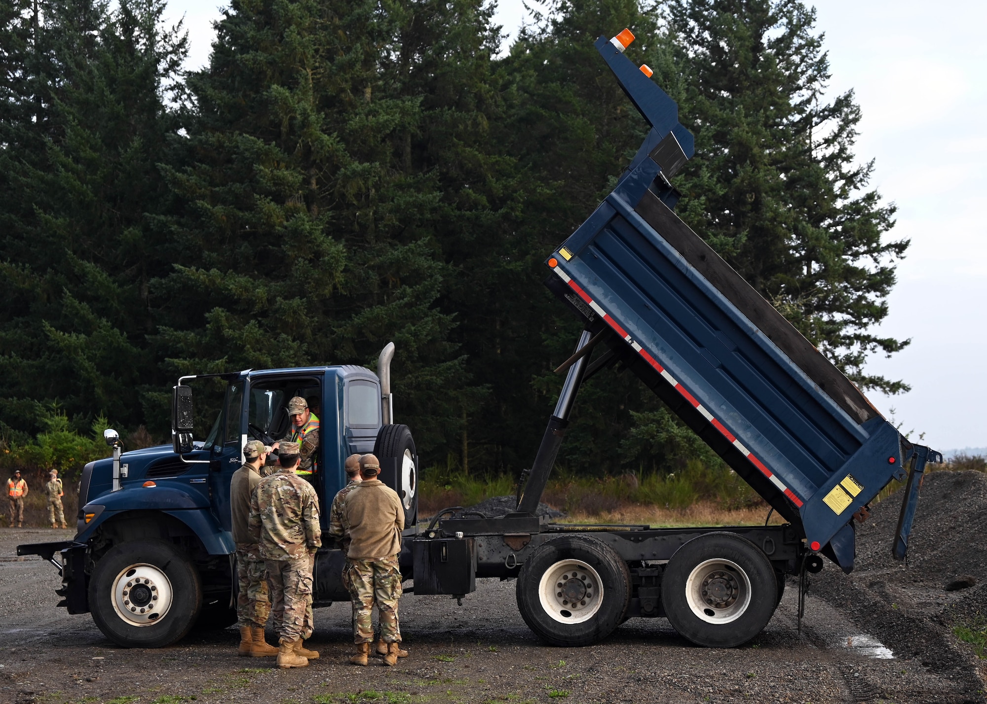 U.S. Air Force Airmen with the 627th Civil Engineer Squadron learn to operate a dump truck during a vehicle rodeo at Joint Base Lewis-McChord, Washington, Oct. 12, 2023. The 627th CES held a vehicle rodeo to license Airmen, so they can operate compact track loaders, backhoes, front end loaders, dump trucks, all terrain forklifts and street sweepers, ensuring multi-capable Airmen capabilities and mission readiness. (U.S. Air Force photo by Senior Airman Callie Norton)