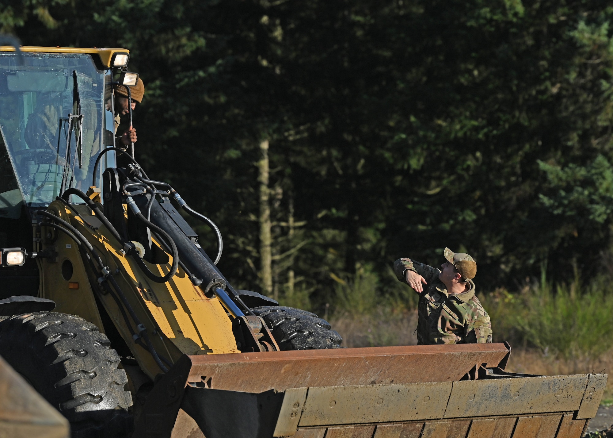 A U.S. Air Force Airman with the 627th Civil Engineer Squadron learns to operate a front loader during a vehicle rodeo at Joint Base Lewis-McChord, Washington, Oct. 12, 2023. The 627th CES held a vehicle rodeo to license Airmen, so they can operate compact track loaders, backhoes, front end loaders, dump trucks, all terrain forklifts and street sweepers, ensuring multi-capable Airmen capabilities and mission readiness. (U.S. Air Force photo by Senior Airman Callie Norton)