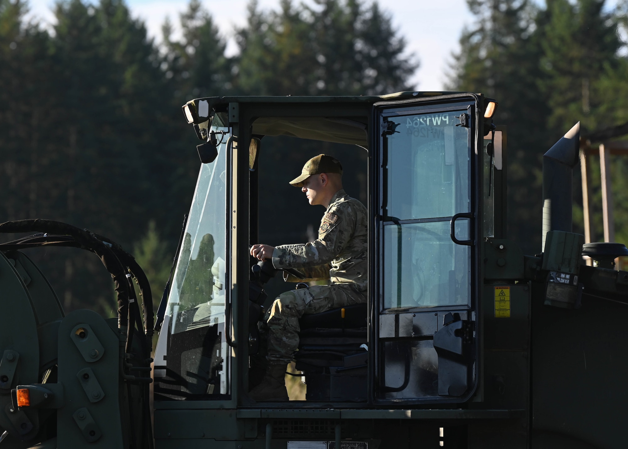 U.S. Air Force Master Sgt. Justin Schuetz, construction inspector with the 627th Civil Engineer Squadron, operates an all-terrain forklift during a vehicle rodeo at Joint Base Lewis-McChord, Washington, Oct. 12, 2023. The 627th CES held a vehicle rodeo to license Airmen, so they can operate compact track loaders, backhoes, front end loaders, dump trucks, all terrain forklifts and street sweepers, ensuring multi-capable Airmen capabilities and mission readiness. (U.S. Air Force photo by Senior Airman Callie Norton)