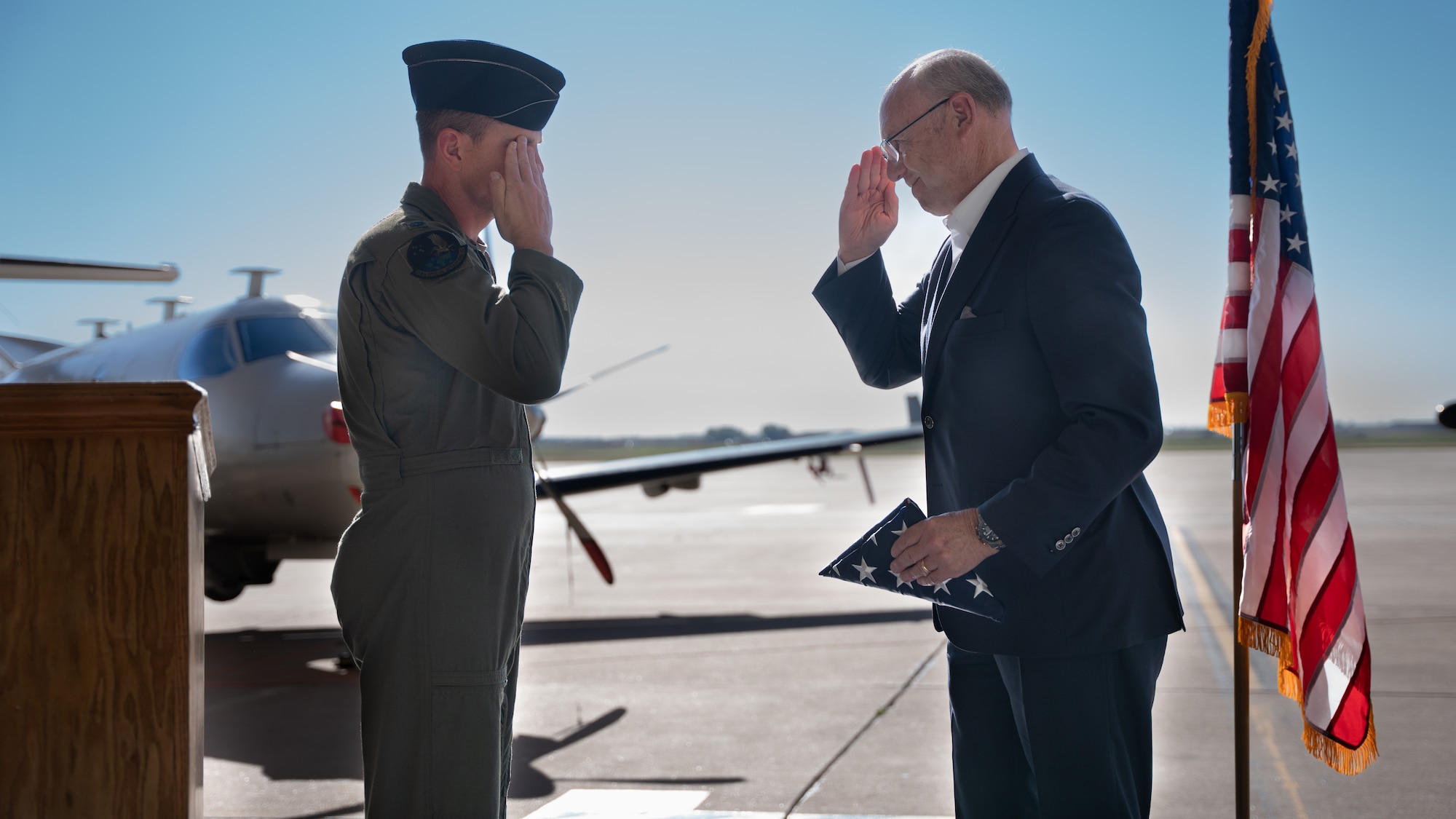 U.S. Air Force retired Maj. Gen. Michael Kingsley receives an American flag from the 318th Special Operations Squadron during his visit Oct. 5, 2023, at Cannon Air Force Base, N.M.