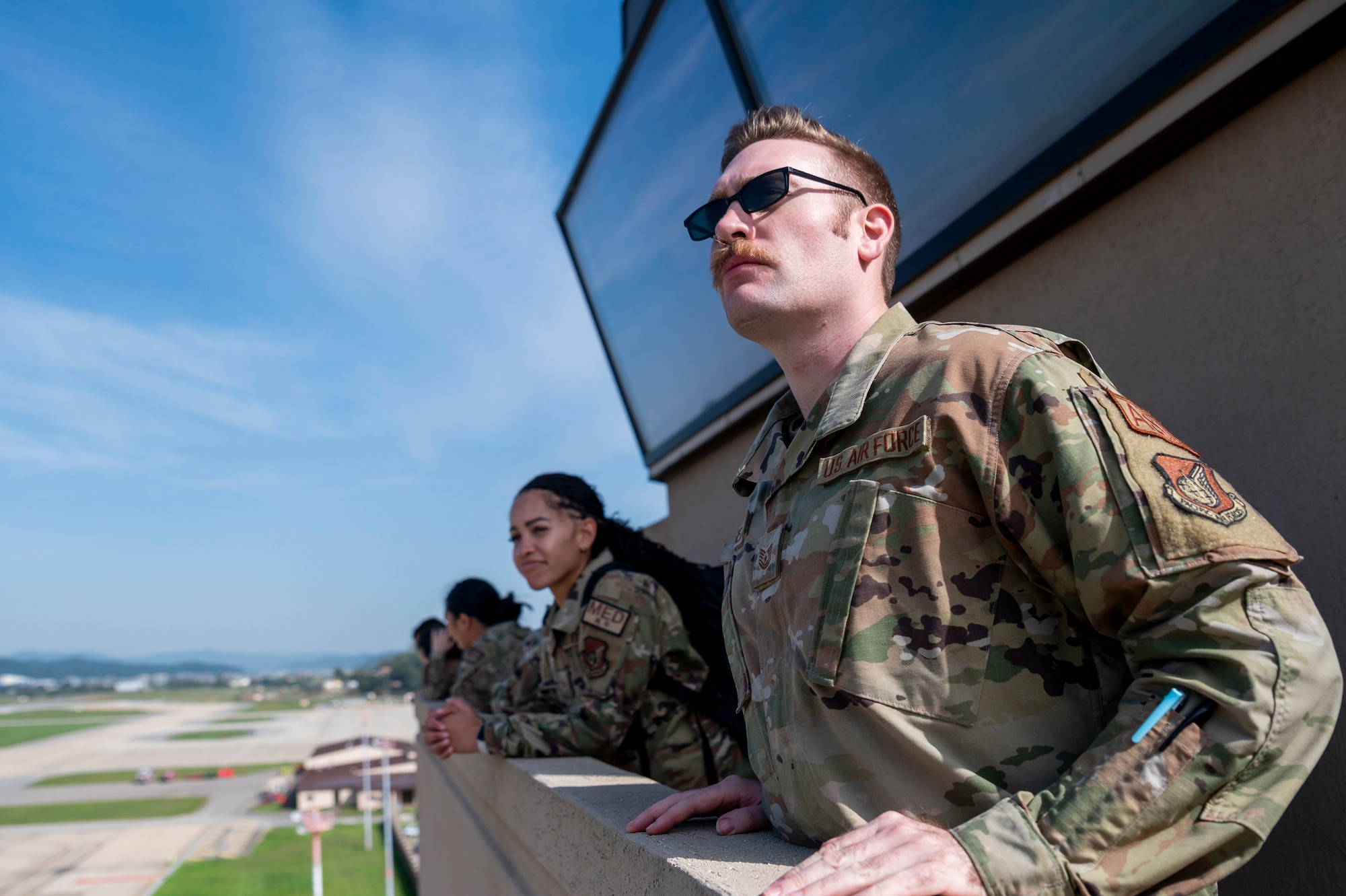 U.S. Air Force Airmen look at the flightline from atop a control tower during a Buddy Squadron event at Osan Air Base, Republic of Korea, Oct. 6, 2023.