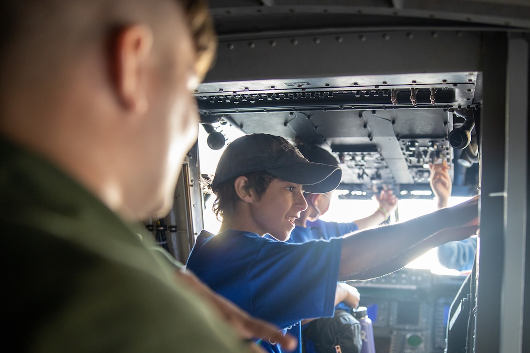 U.S. Marines with Marine Medium Tiltrotor Squadron 268 (VMM-268), Marine Aircraft Group 24, 1st Marine Aircraft Wing, give a tour of the inside of an MV-22B Osprey at Marine Corps Air Station Kaneohe Bay, Hawaii, June 27, 2023. VMM-268 partnered with the Pearl Harbor Aviation Museum’s “Flight School” summer camp to introduce middle school students to the aviation career field and enhance community relations. (U.S. Marine Corps photo by Cpl. Logan Beeney)