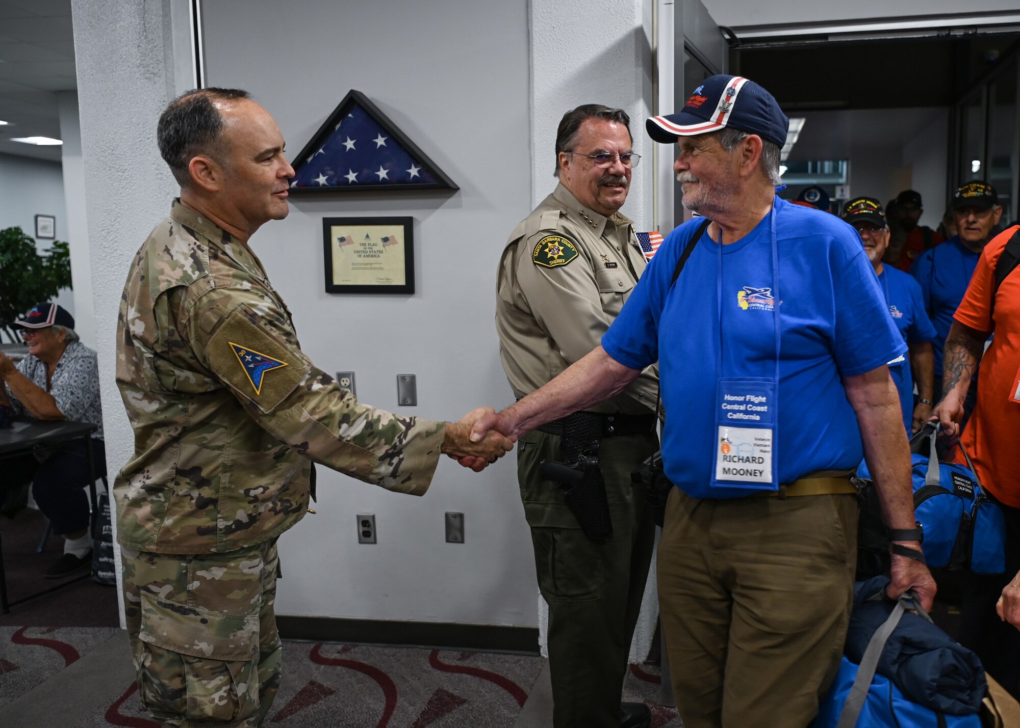 Military member welcomes home veterans at Santa Maria Public Airport.