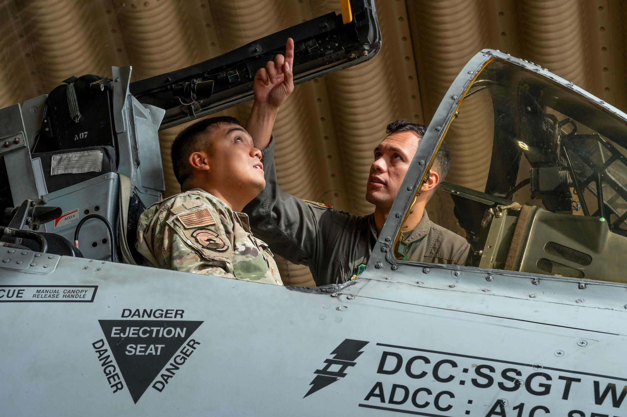 U.S. Air Force Capt. Makoa Tyndall, 25th Fighter Squadron director of staff, explains the A-10C Thunderbolt II cockpit features to Tech. Sgt. Dean Sigismundo, 51st Communications Squadron quality assurance noncommissioned officer in charge, at Osan Air Base, Republic of Korea, Oct. 6, 2023.