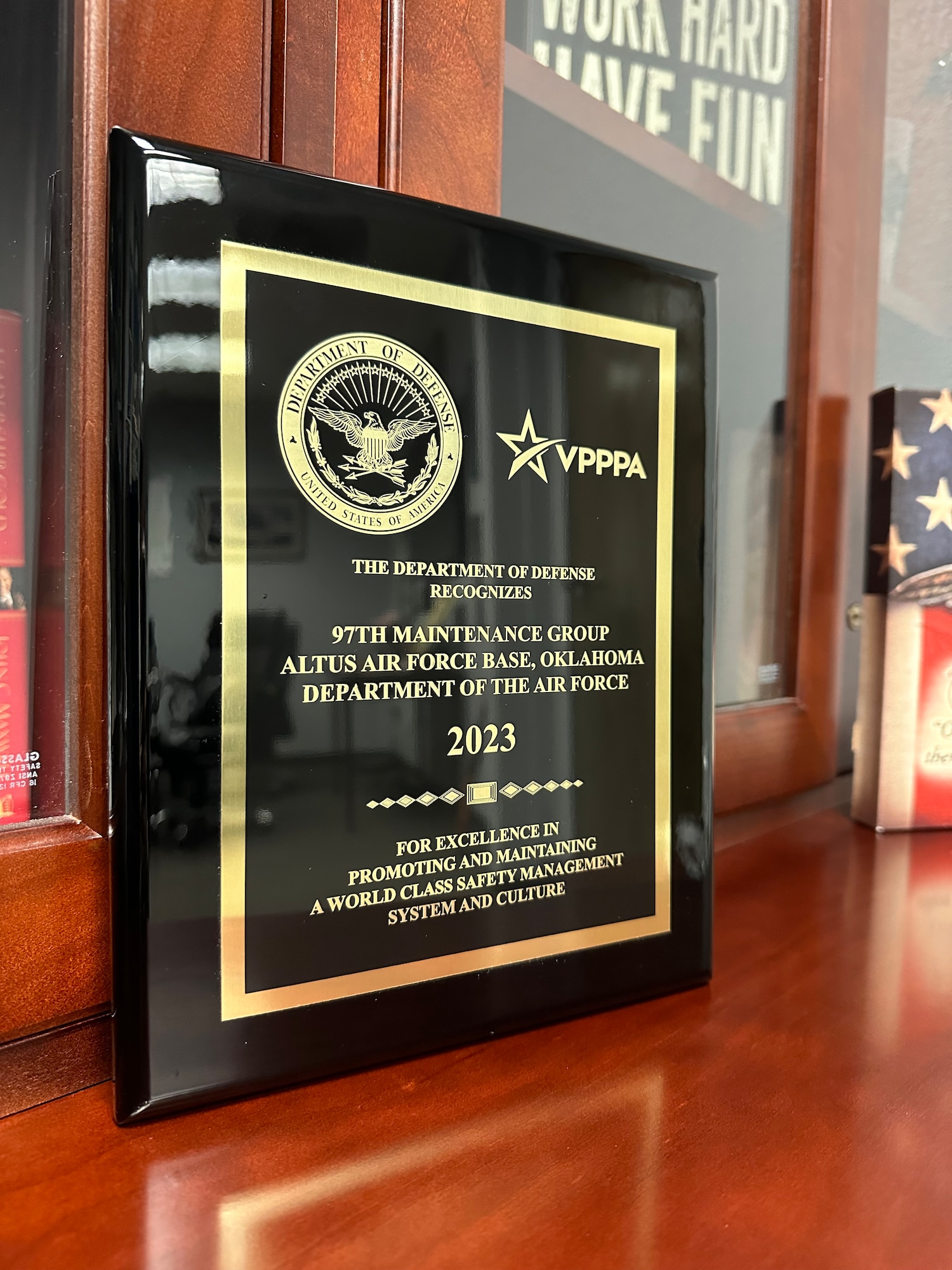 The 2023 Department of Defense Safety and Occupational Health Management System Achievement Award is showcased on a desk at Altus Air Force Base (AFB), Oklahoma, October 3, 2023. A group of experts evaluated the nominations and chose the 97th Maintenance Group at Altus AFB as the winner of the award. (U.S. Air Force photo by Senior Airman Trenton Jancze)