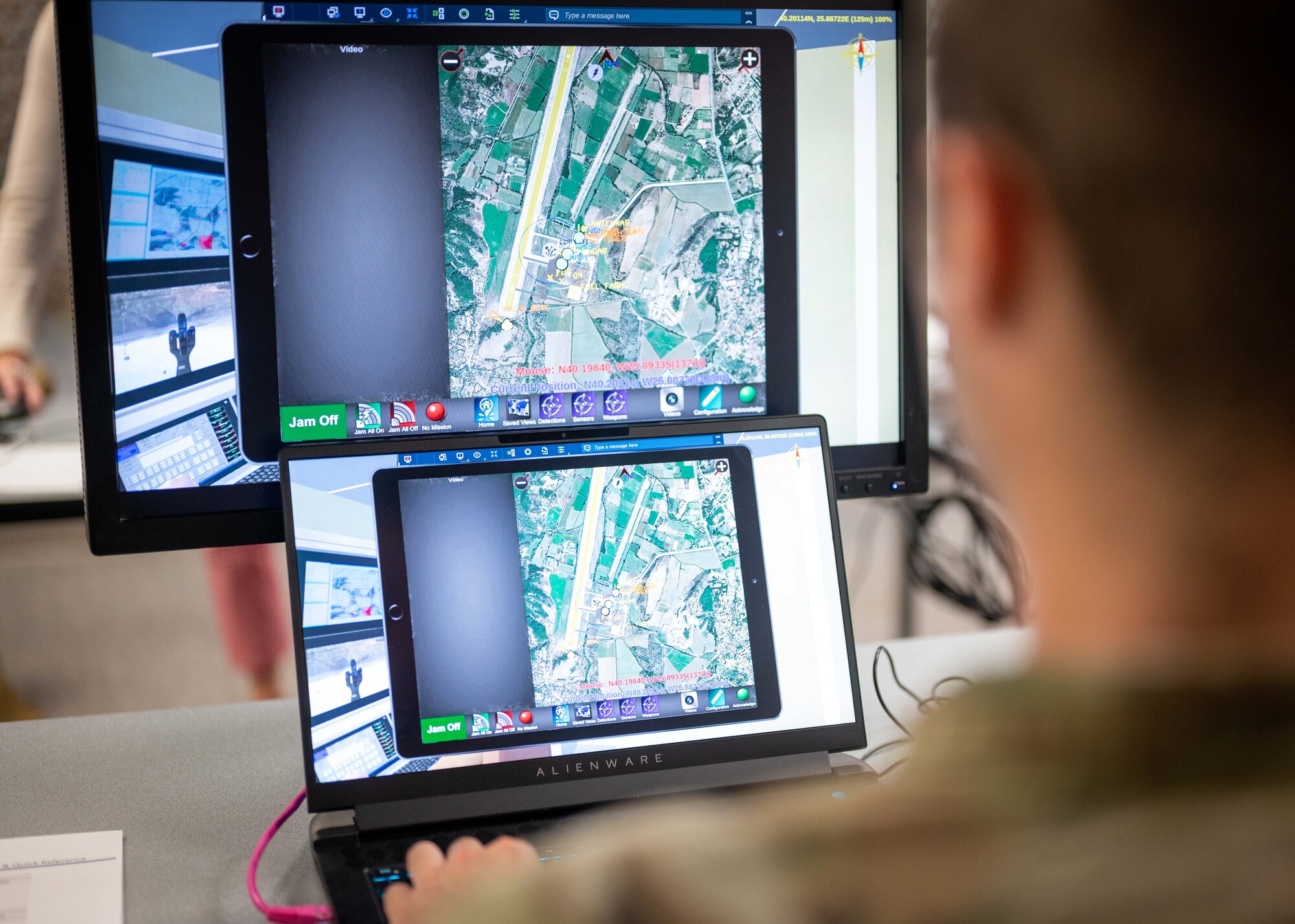 Airman reviews simulated maps on a computer screen.