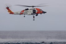 U.S. Coast Guardsmen with Coast Guard Sector San Diego, District 11, participate in a search and rescue exercise with U.S. Marines with 3rd Marine Aircraft Wing near the coast of San Diego, California,