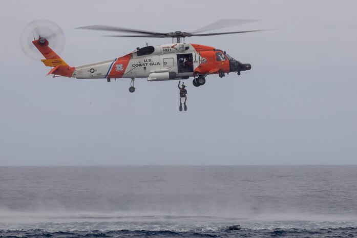 U.S. Coast Guardsmen with Coast Guard Sector San Diego, District 11, participate in a search and rescue exercise with U.S. Marines with 3rd Marine Aircraft Wing near the coast of San Diego, California,