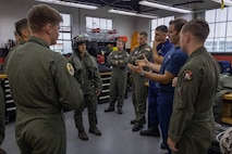 U.S. Marine Corps Capt. Peter Lindsey, a pilot with Marine Fighter Attack Training Squadron (VMFAT) 502, Marine Aircraft Group 11, 3rd Marine Aircraft Wing, demonstrates the aviation life support equipment worn by F-35B Lightning II pilots