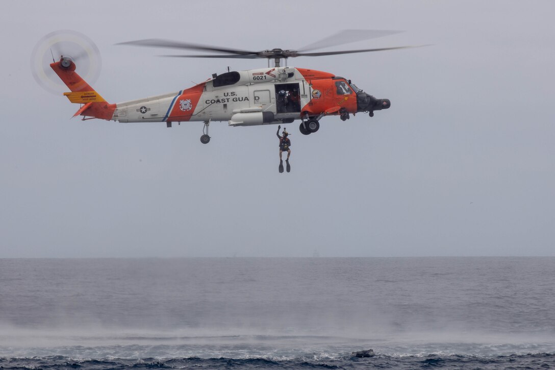 U.S. Coast Guardsmen with Coast Guard Sector San Diego, District 11, participate in a search and rescue exercise with U.S. Marines with 3rd Marine Aircraft Wing near the coast of San Diego, California,