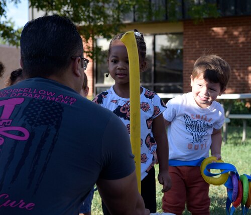 Daniel Chapa, Goodfellow Fire Department shift captain, interacts with youth at the Child Development Center at Goodfellow Air Force Base, Texas, Oct. 10, 2023.